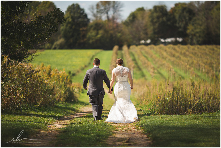 Couple walking through vineyard | Wedding Photographer